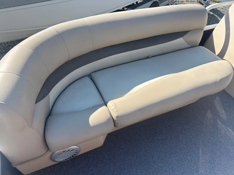 Slide: The Image of 2016 Sun Tracker Party Barge 18 DLX boat seat, beige upholstery, curved design. - 20