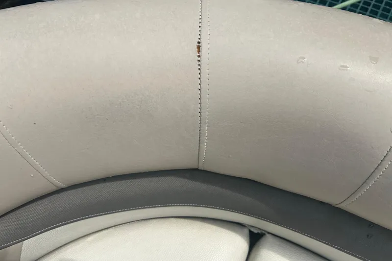 Slide: The Image of Close-up of 2016 Sun Tracker Party Barge 18 DLX seat with visible stitching and water droplets. - 21