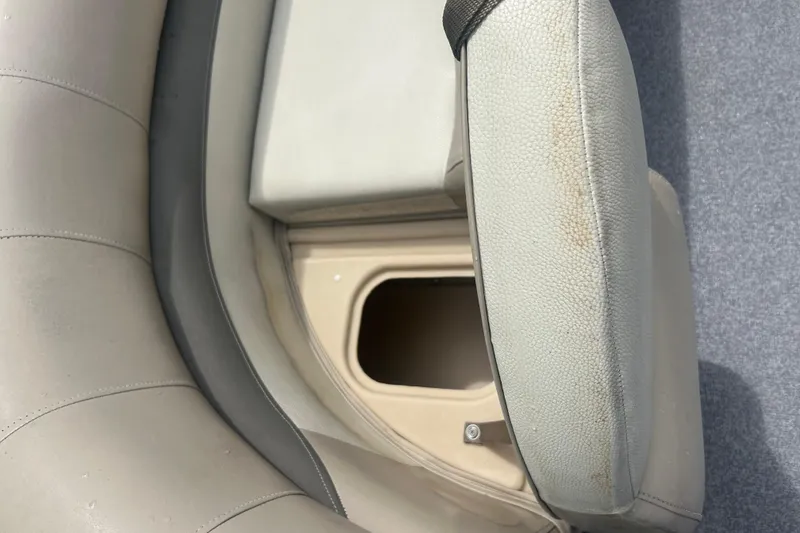 Slide: The Image of 2016 Sun Tracker Party Barge 18 DLX seat storage compartment, beige upholstery, open lid. - 25