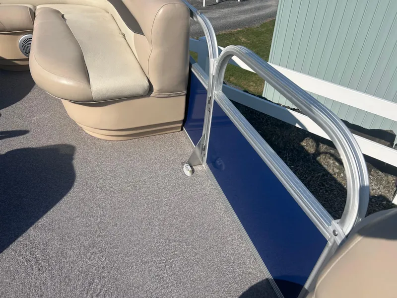 Slide: The Image of 2016 Sun Tracker Party Barge 18 DLX with beige seating and blue paneling. - 26