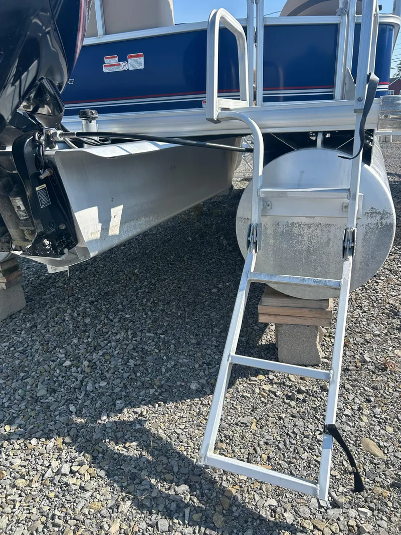 Slide: The Image of 2016 Sun Tracker Party Barge 18 DLX with ladder on gravel surface. - 28