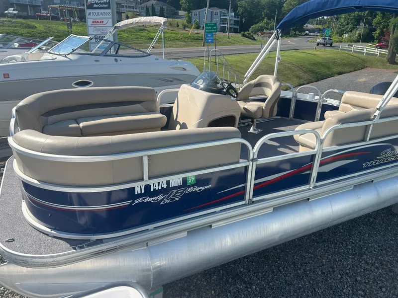Slide: The Image of 2016 Sun Tracker Party Barge 18 DLX pontoon boat with beige seating and blue exterior. - 3
