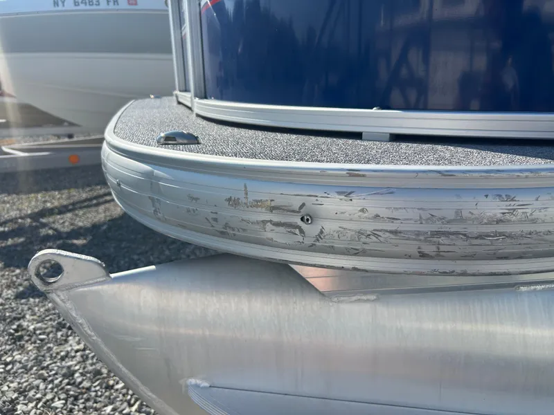 Slide: The Image of Close-up of 2016 Sun Tracker Party Barge 18 DLX pontoon with visible scratches. - 9