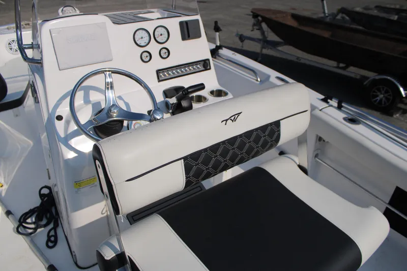Slide: The Image of 2021 Tidewater 198 CC Adventure boat cockpit with steering wheel and control panel. - 10