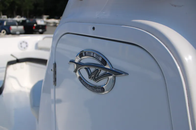 Slide: The Image of 2021 Tidewater 198 CC Adventure boat emblem on white surface. - 14