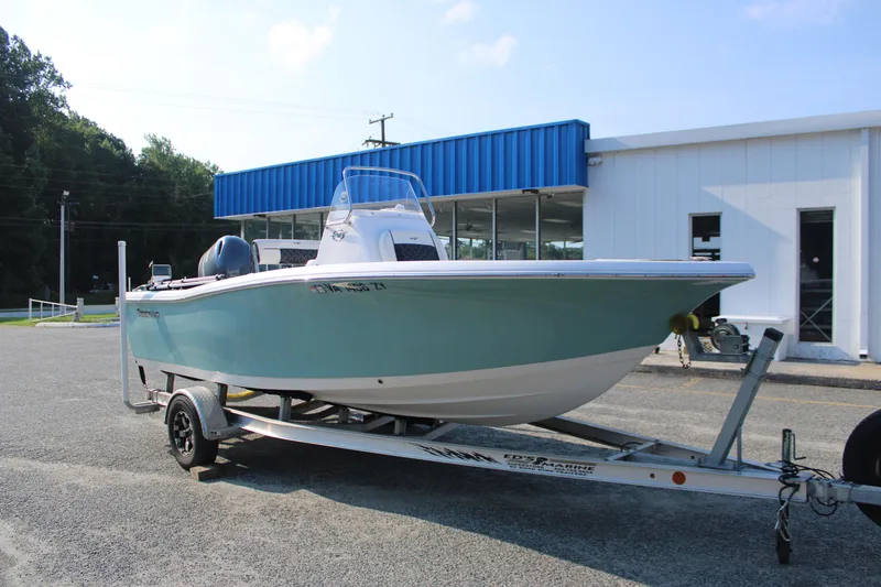 Slide: The Image of 2021 Tidewater 198 CC Adventure boat on trailer, parked outside a building. - 3