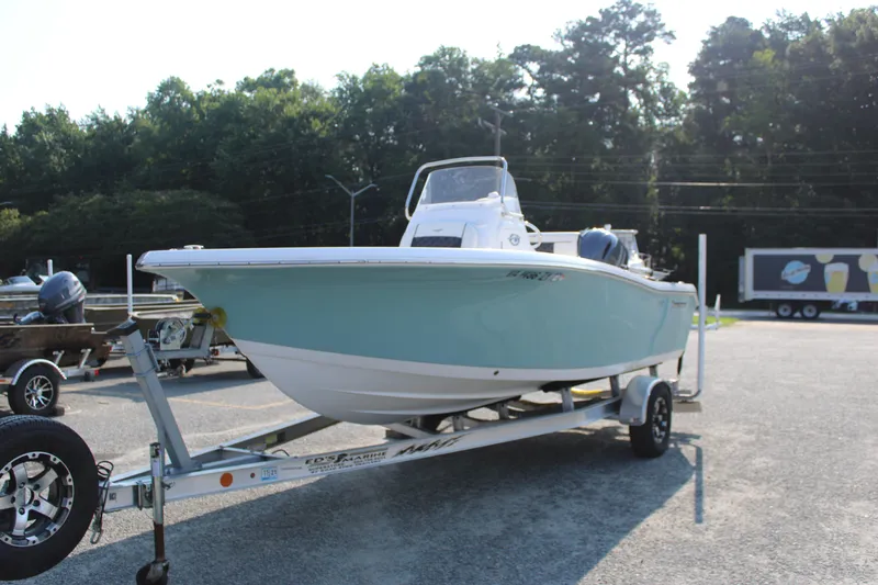 Slide: The Image of 2021 Tidewater 198 CC Adventure boat on trailer, parked outdoors. - 4