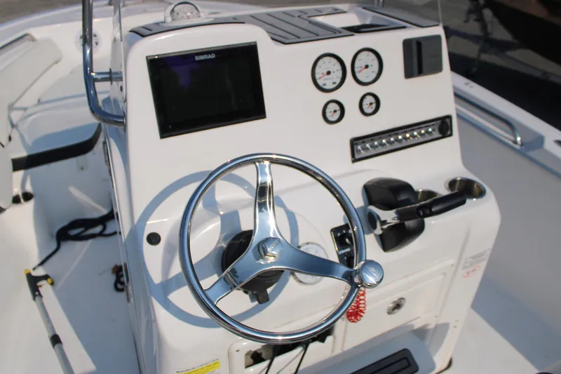 Slide: The Image of 2021 Tidewater 198 CC Adventure boat console with steering wheel and gauges. - 8