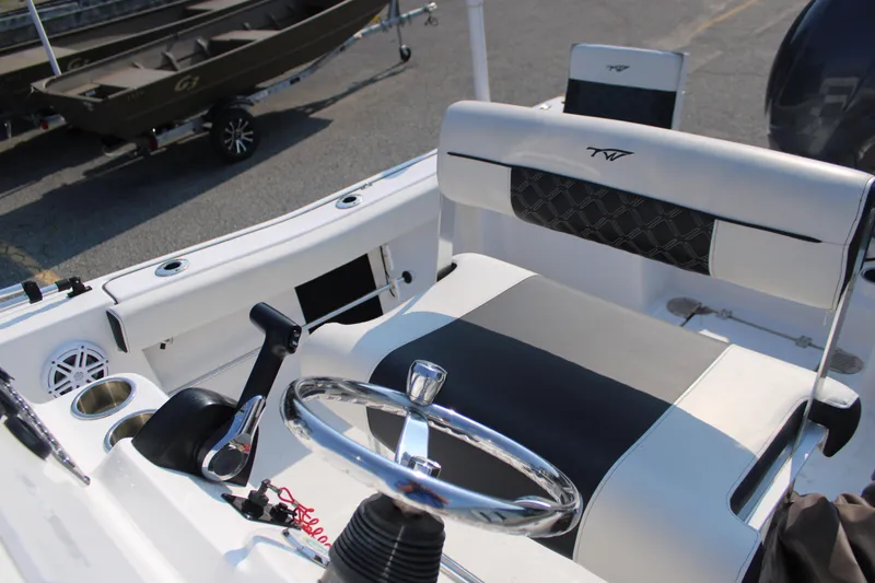 Slide: The Image of 2021 Tidewater 198 CC Adventure boat interior with steering wheel and seating. - 9