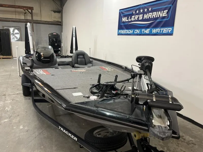 Slide: The Image of 2020 Tracker Pro Team 195 TXW boat in showroom, featuring fishing equipment and Miller's Marine banner. - 2