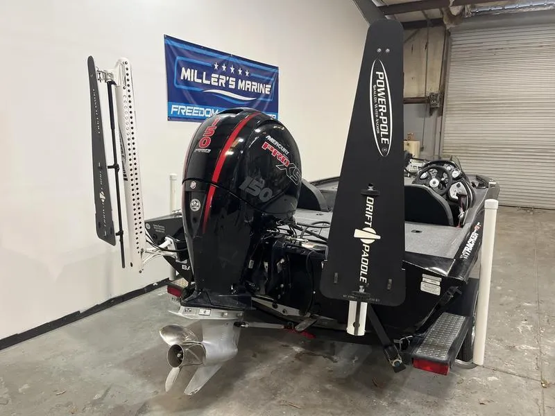 Slide: The Image of 2020 Tracker Pro Team 195 TXW boat with Mercury engine and Power-Pole anchors in a showroom. - 3