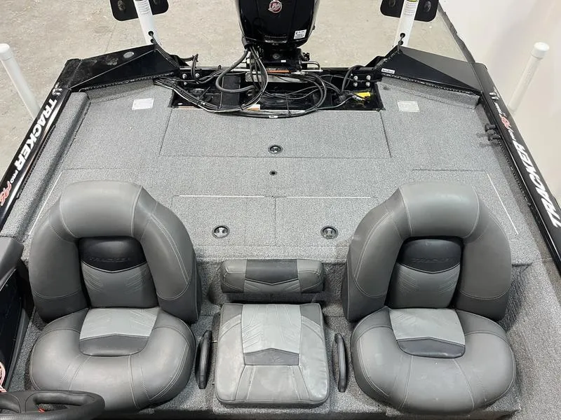 Slide: The Image of 2020 Tracker Pro Team 195 TXW boat interior with gray seating and motor. - 4