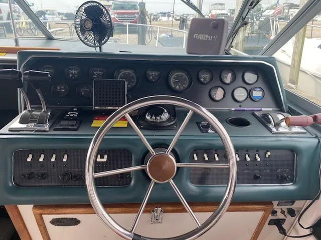 Slide: The Image of 1987 Sea Ray 300 Weekender helm with steering wheel, gauges, and controls. - 11