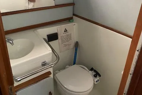 Slide: The Image of 1987 Sea Ray 300 Weekender boat bathroom with sink and toilet. - 15
