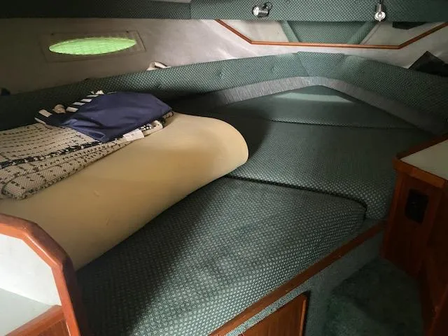 Slide: The Image of 1987 Sea Ray 300 Weekender cabin interior with green upholstery and bedding. - 19