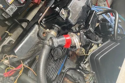 Slide: The Image of Engine components of a 1987 Sea Ray 300 Weekender boat, featuring hoses and wiring. - 20