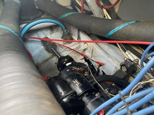 Slide: The Image of Engine compartment of a 1987 Sea Ray 300 Weekender with visible hoses and wiring. - 21
