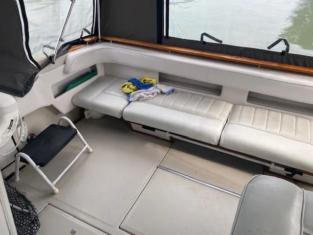 Slide: The Image of 1987 Sea Ray 300 Weekender interior with white seating and step ladder. - 6