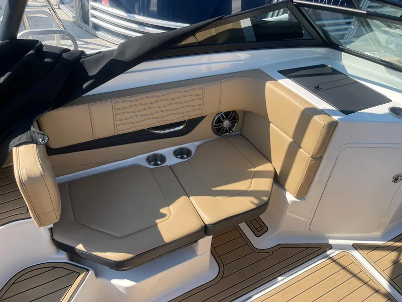 Slide: The Image of 2023 Sea Ray SPX 190 boat interior with tan seating and cup holders. - 4