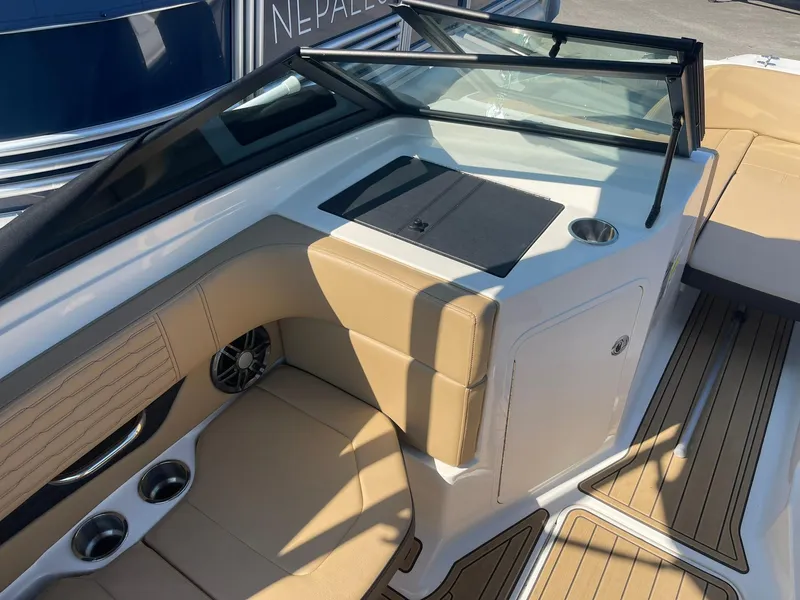 Slide: The Image of 2023 Sea Ray SPX 190 boat interior with tan seating and cup holders. - 7