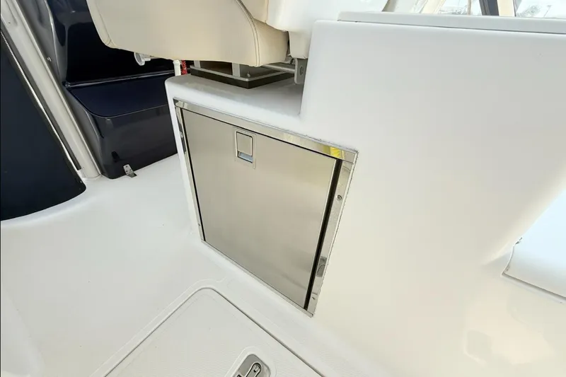 Slide: The Image of 2015 Pursuit ST 310 Sport interior with stainless steel storage compartment. - 11