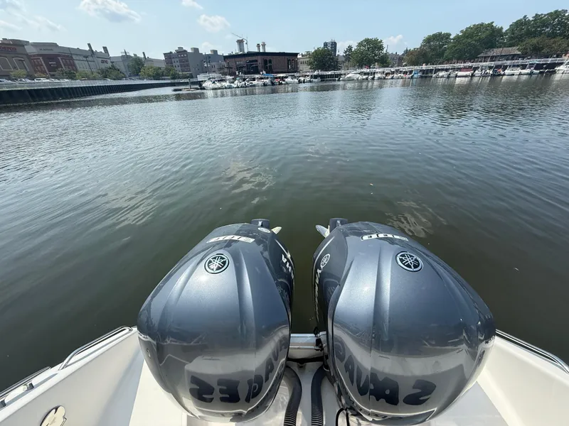 Slide: The Image of 2015 Pursuit ST 310 Sport boat with dual Yamaha outboard motors on a calm river. - 4