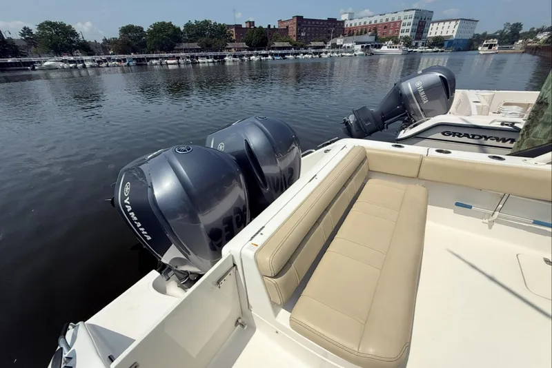 Slide: The Image of 2015 Pursuit ST 310 Sport boat with Yamaha engines docked by a riverside. - 5