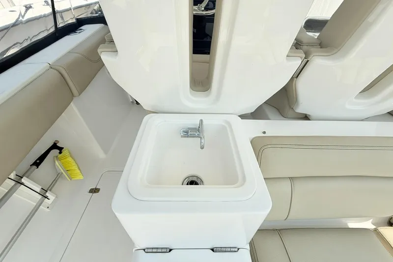 Slide: The Image of Interior of 2015 Pursuit ST 310 Sport boat with sink and seating area. - 8