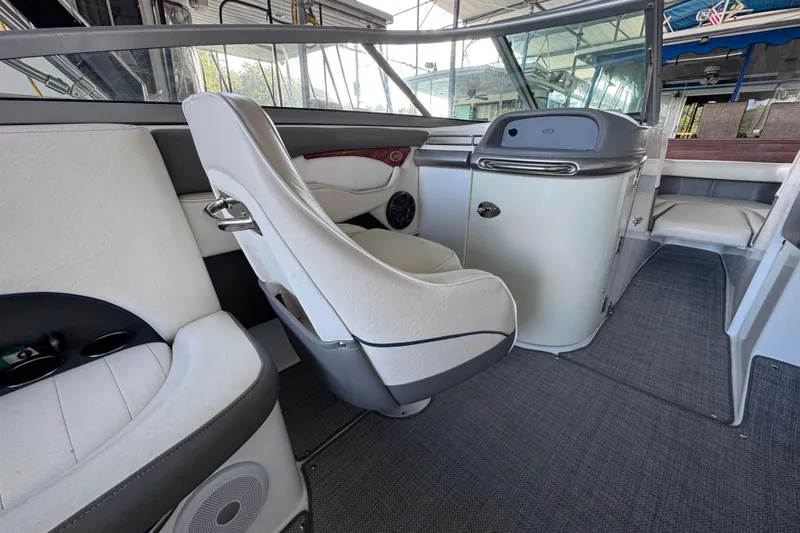 Slide: The Image of Interior of a 2006 Cobalt 240 boat, featuring white seating and modern dashboard. - 17