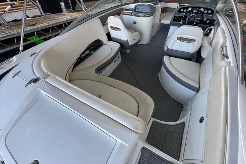 Slide: The Image of Interior of a 2006 Cobalt 240 boat with white seating and dashboard. - 18