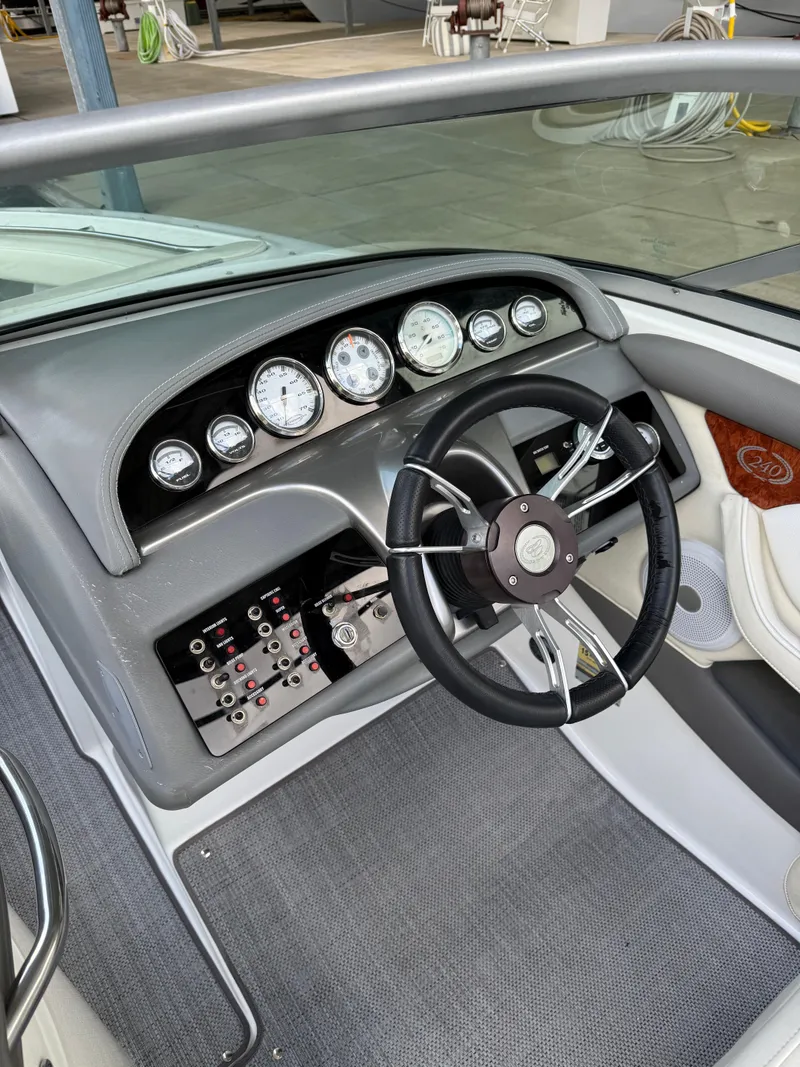 Slide: The Image of 2006 Cobalt 240 boat dashboard with steering wheel and instrument panel. - 19