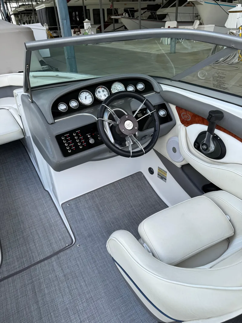 Slide: The Image of 2006 Cobalt 240 boat interior with steering wheel and dashboard controls. - 20