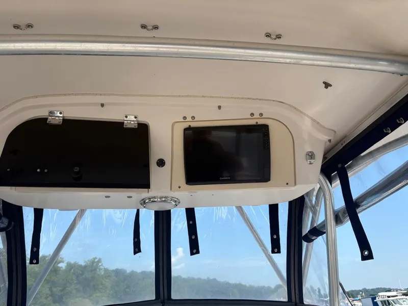 Slide: The Image of 2003 Grady-White Sailfish 282 boat interior with navigation equipment and storage compartments. - 11