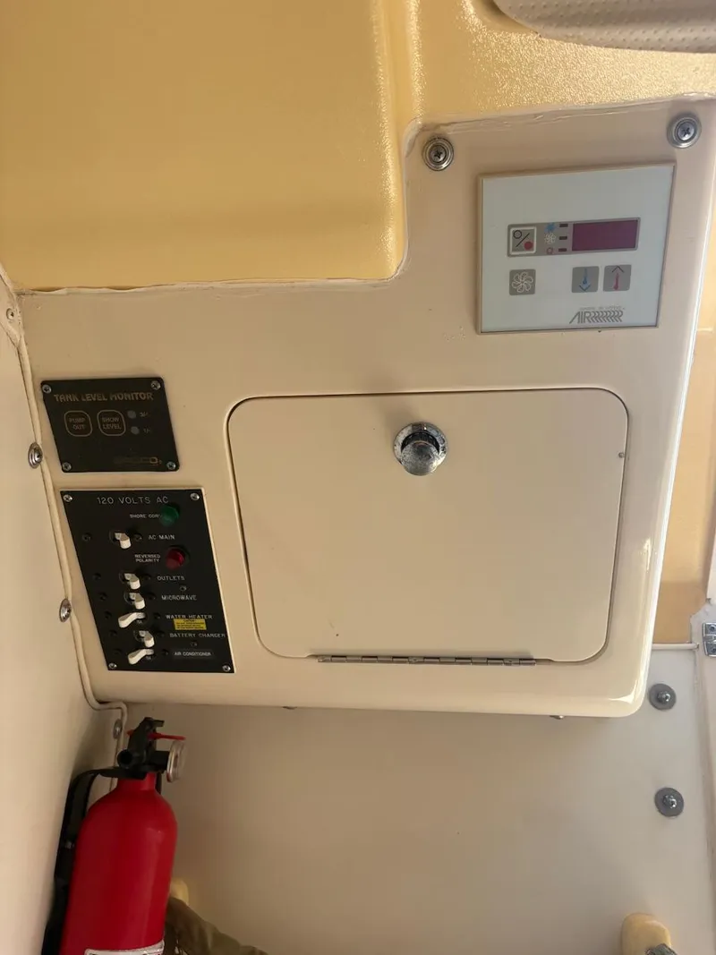 Slide: The Image of Control panel of a 2003 Grady-White Sailfish 282 boat with fire extinguisher. - 12