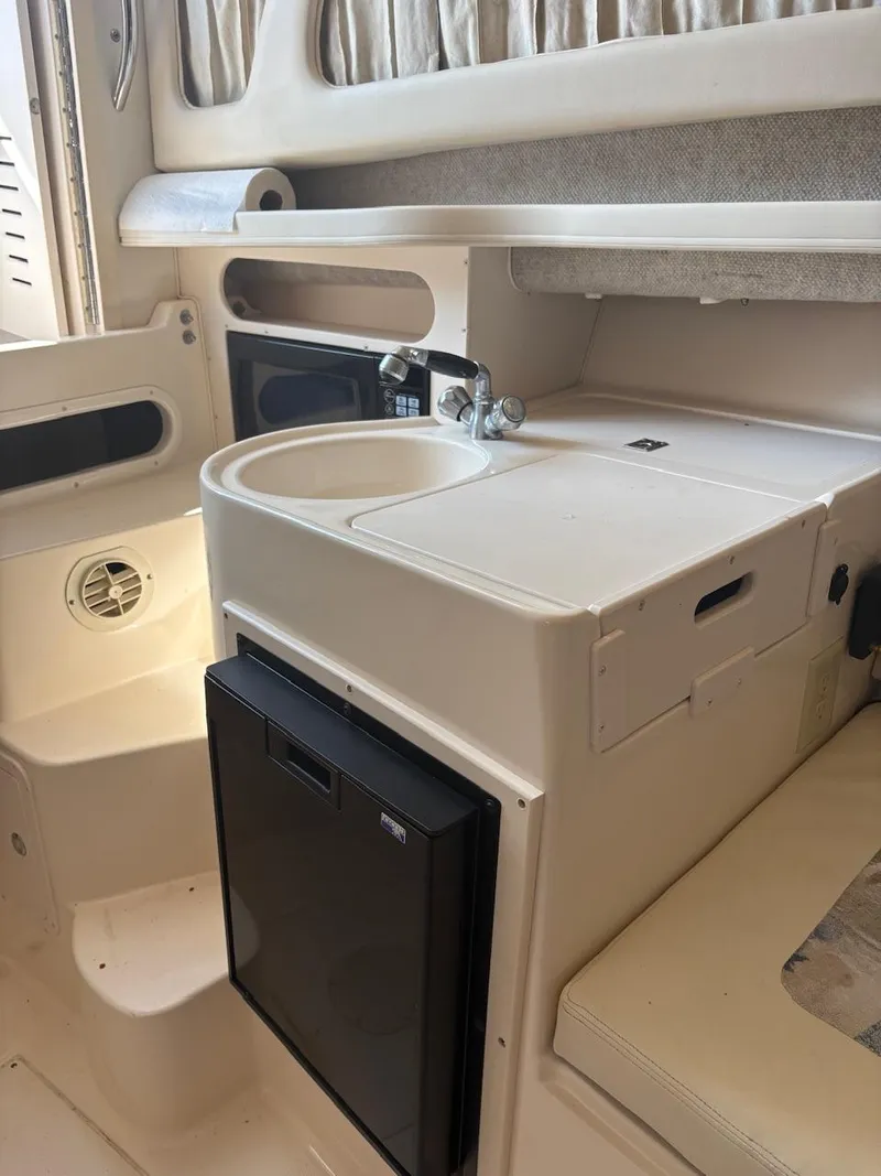 Slide: The Image of 2003 Grady-White Sailfish 282 boat interior with sink and mini fridge. - 13