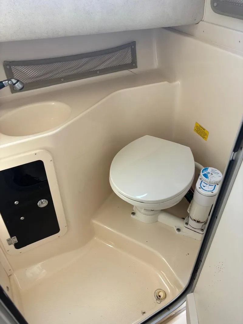 Slide: The Image of 2003 Grady-White Sailfish 282 boat bathroom with toilet and sink. - 14