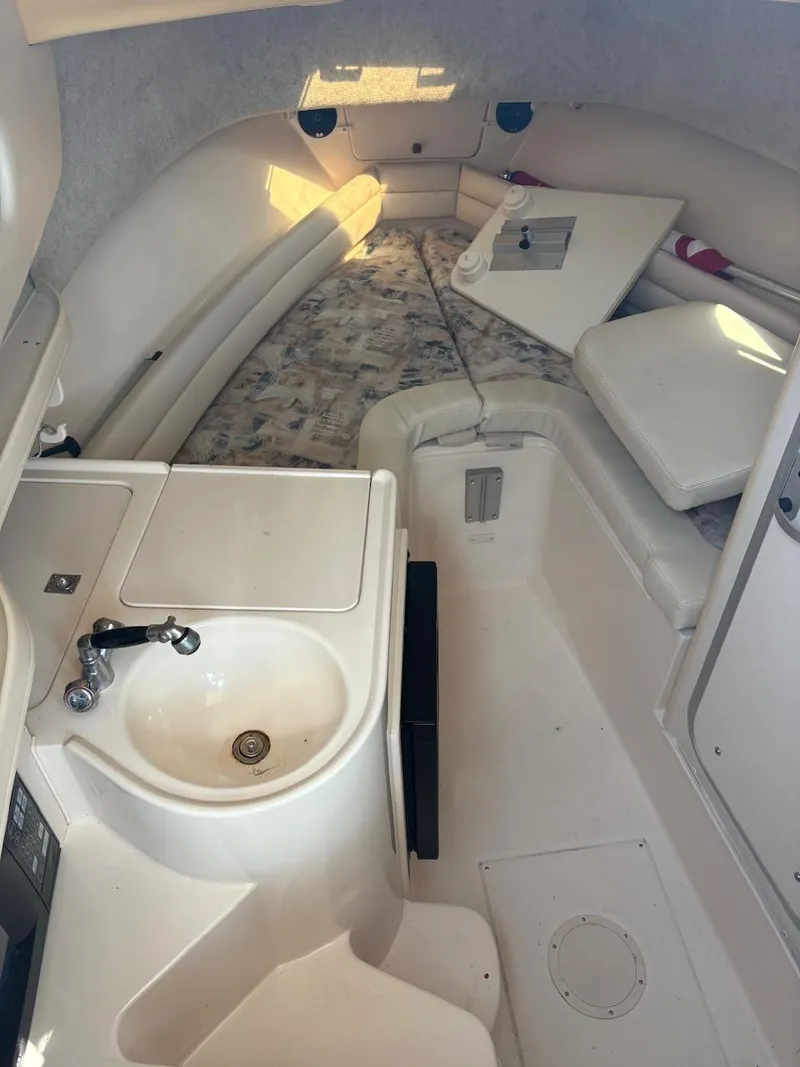 Slide: The Image of 2003 Grady-White Sailfish 282 cabin interior with sink and seating area. - 16