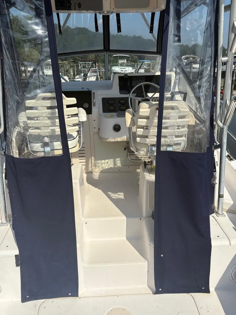 Slide: The Image of 2003 Grady-White Sailfish 282 boat interior with helm and seating area. - 7