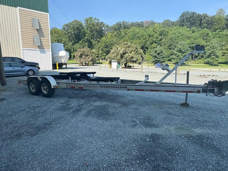 Slide: The Image of Trailer for 2003 Grady-White Sailfish 282, parked on gravel near trees and building. - 9