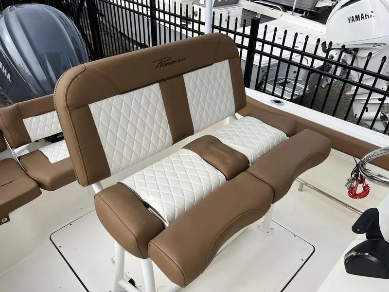 Slide: The Image of Brown and white seating on 2026 Pioneer 222 Islander boat, featuring diamond stitching. - 14