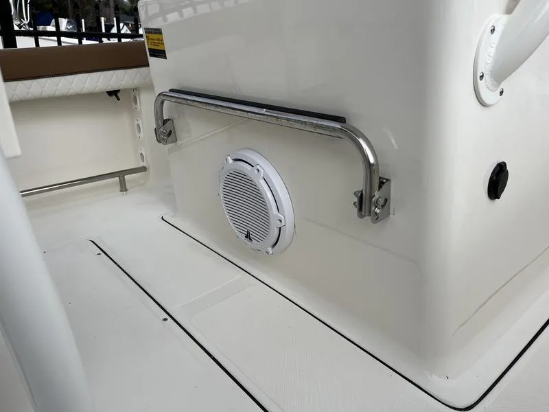 Slide: The Image of 2026 Pioneer 222 Islander boat interior with speaker and stainless steel handrail. - 15