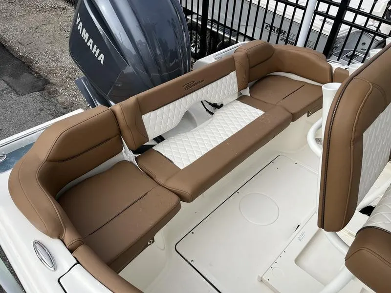 Slide: The Image of 2026 Pioneer 222 Islander boat interior with brown and white cushioned seating. - 17