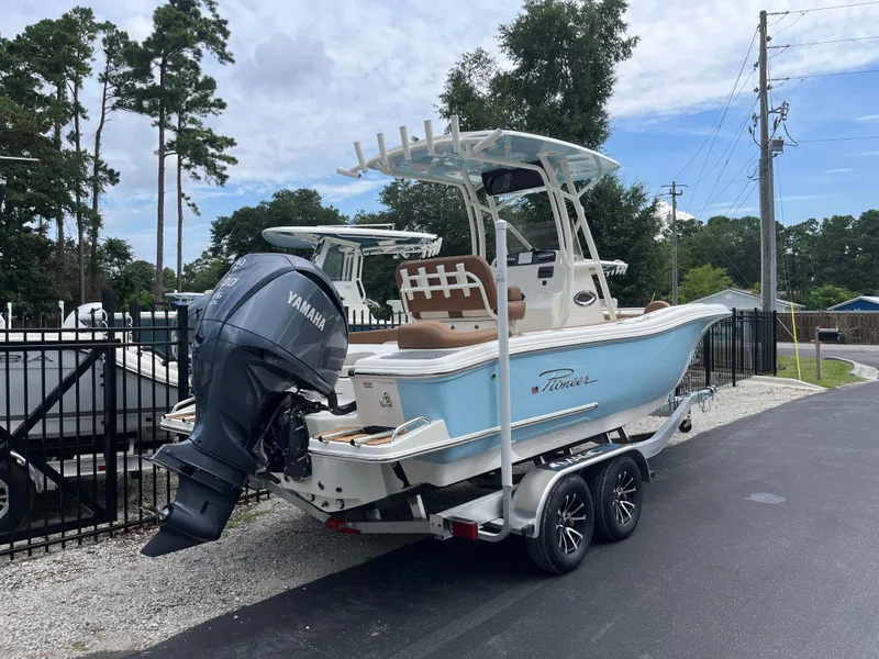 Slide: The Image of 2026 Pioneer 222 Islander boat with Yamaha engine on trailer, parked outdoors. - 2