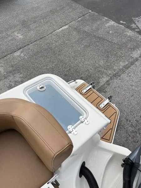 Slide: The Image of 2026 Pioneer 222 Islander boat with tan seating and swim platform. - 20