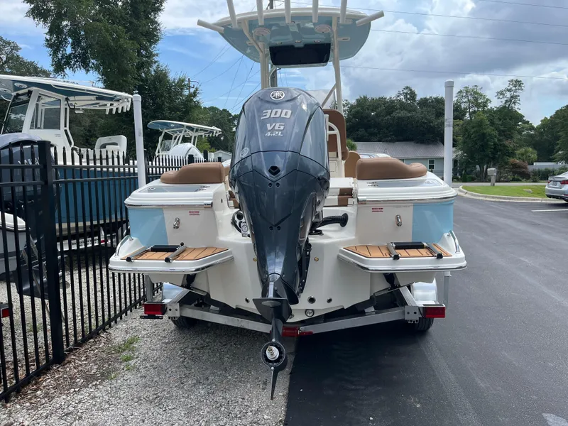 Slide: The Image of 2026 Pioneer 222 Islander boat with powerful V6 engine, parked outdoors. - 3