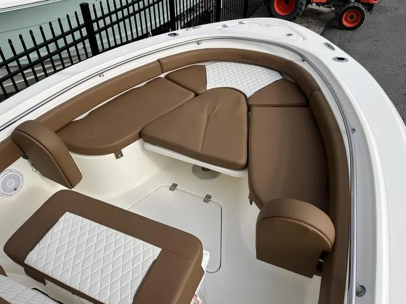 Slide: The Image of 2026 Pioneer 222 Islander boat interior with brown and white cushioned seating. - 5
