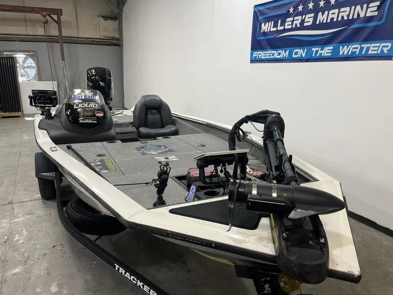Slide: The Image of 2019 Tracker Pro Team 175 TXW boat in showroom, featuring fishing equipment and Miller's Marine banner. - 2