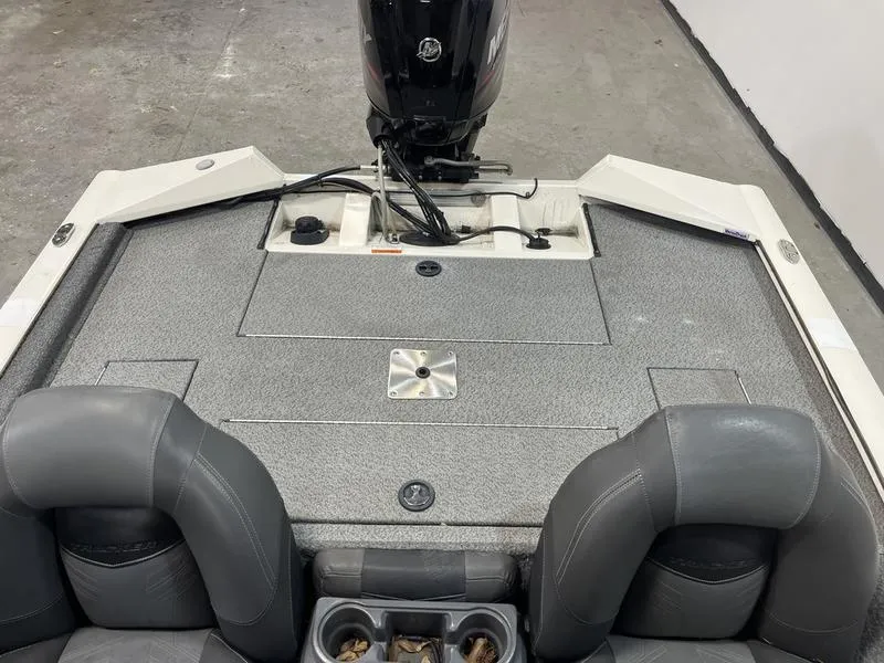 Slide: The Image of 2019 Tracker Pro Team 175 TXW boat interior with motor and seating. - 5