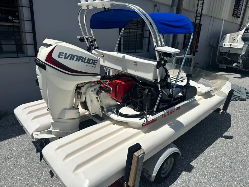Slide: The Image of 2020 CraigCat E2 Elite with Evinrude E-TEC engine on trailer, blue canopy. - 13