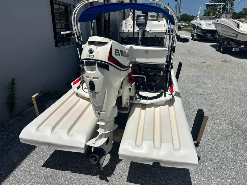 Slide: The Image of 2020 CraigCat E2 Elite with Evinrude 30 HP outboard motor, parked outdoors. - 14